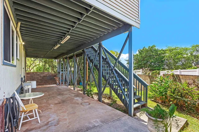 a view of a chair and tables in the balcony