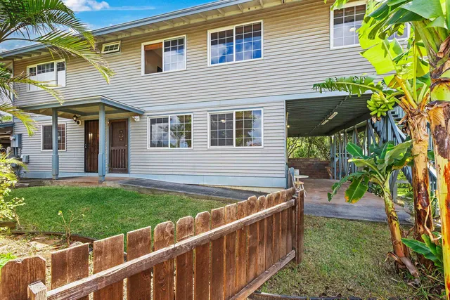 a view of a house with a yard and sitting area