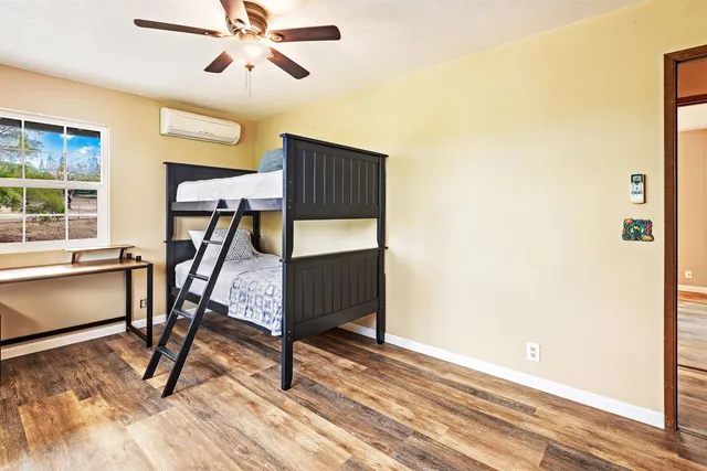 a bedroom with bunk bed and a window