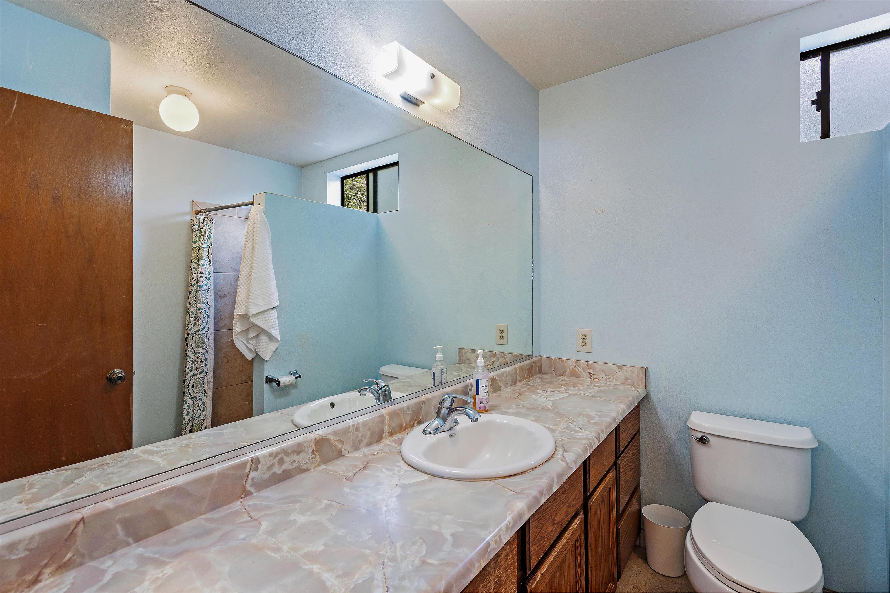 31 Pualu Loop Lahaina, HI 96761 - Photo 31 of 40 a bathroom with a granite countertop sink toilet and mirror