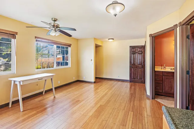 a view of a livingroom with wooden floor and a window