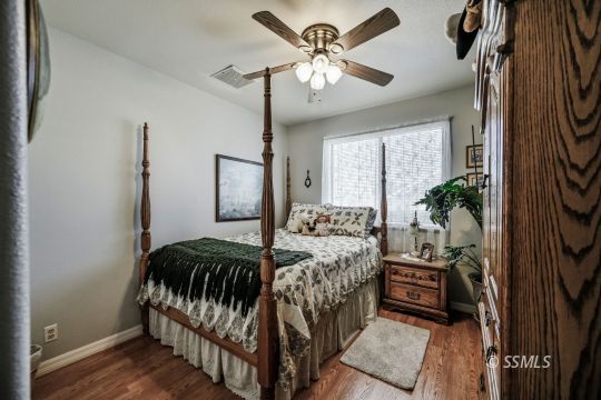 1213 Andrea Court Ridgecrest, CA 93555 - Photo 35 of 50 a bedroom with a bed and a chandelier