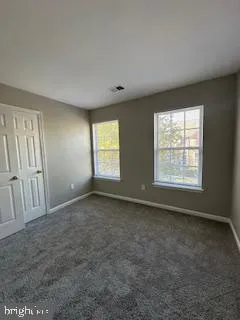 an empty room with wooden floor and fireplace