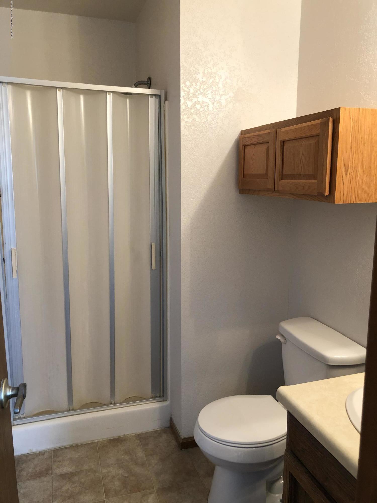 620 Elm Court Rifle, CO 81650 - Photo 11 of 16 a bathroom with a toilet a sink and mirror