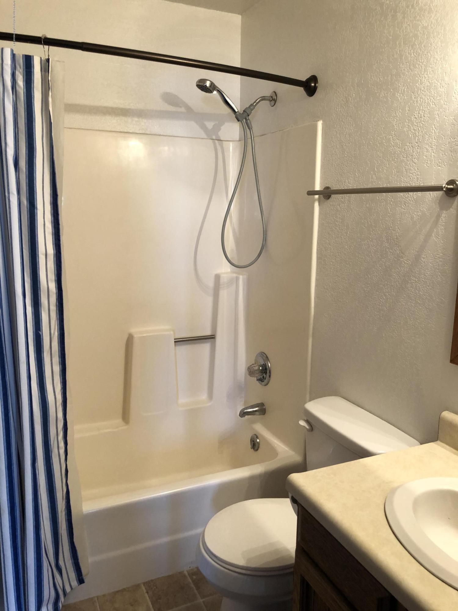 620 Elm Court Rifle, CO 81650 - Photo 12 of 16 a bathroom with a sink toilet and shower