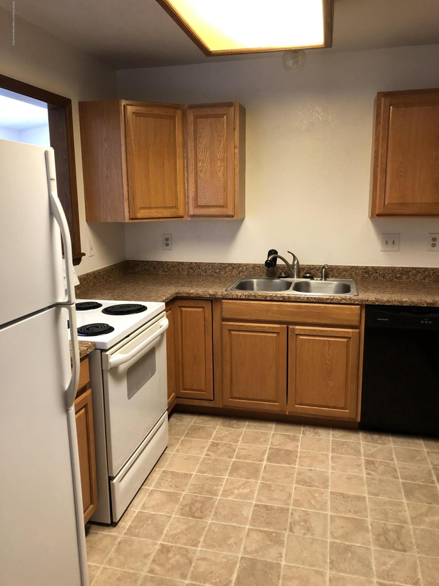 620 Elm Court Rifle, CO 81650 - Photo 5 of 16 a kitchen with a stove a sink dishwasher and a refrigerator