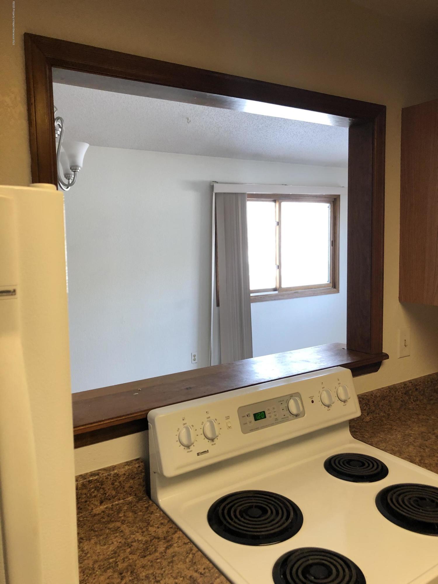 620 Elm Court Rifle, CO 81650 - Photo 6 of 16 a room with a stove and a wooden floor
