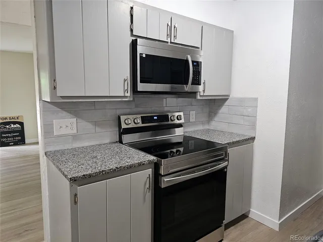 a kitchen with a stove and a microwave