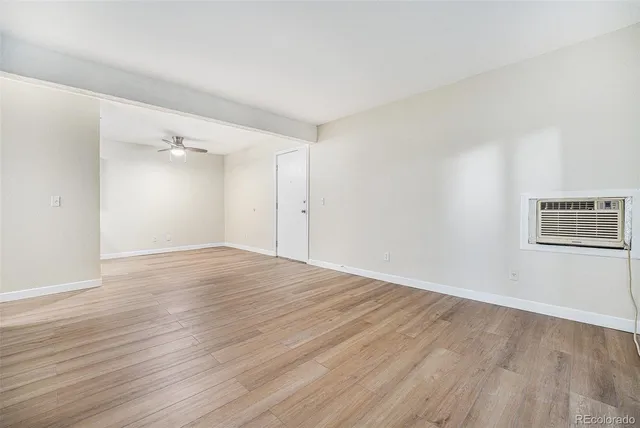 a view of an empty room with wooden floor