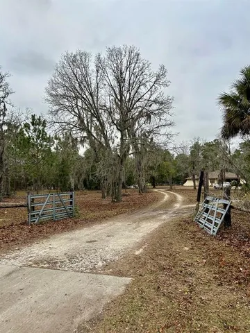 a backyard of a house with barbeque oven table and chairs