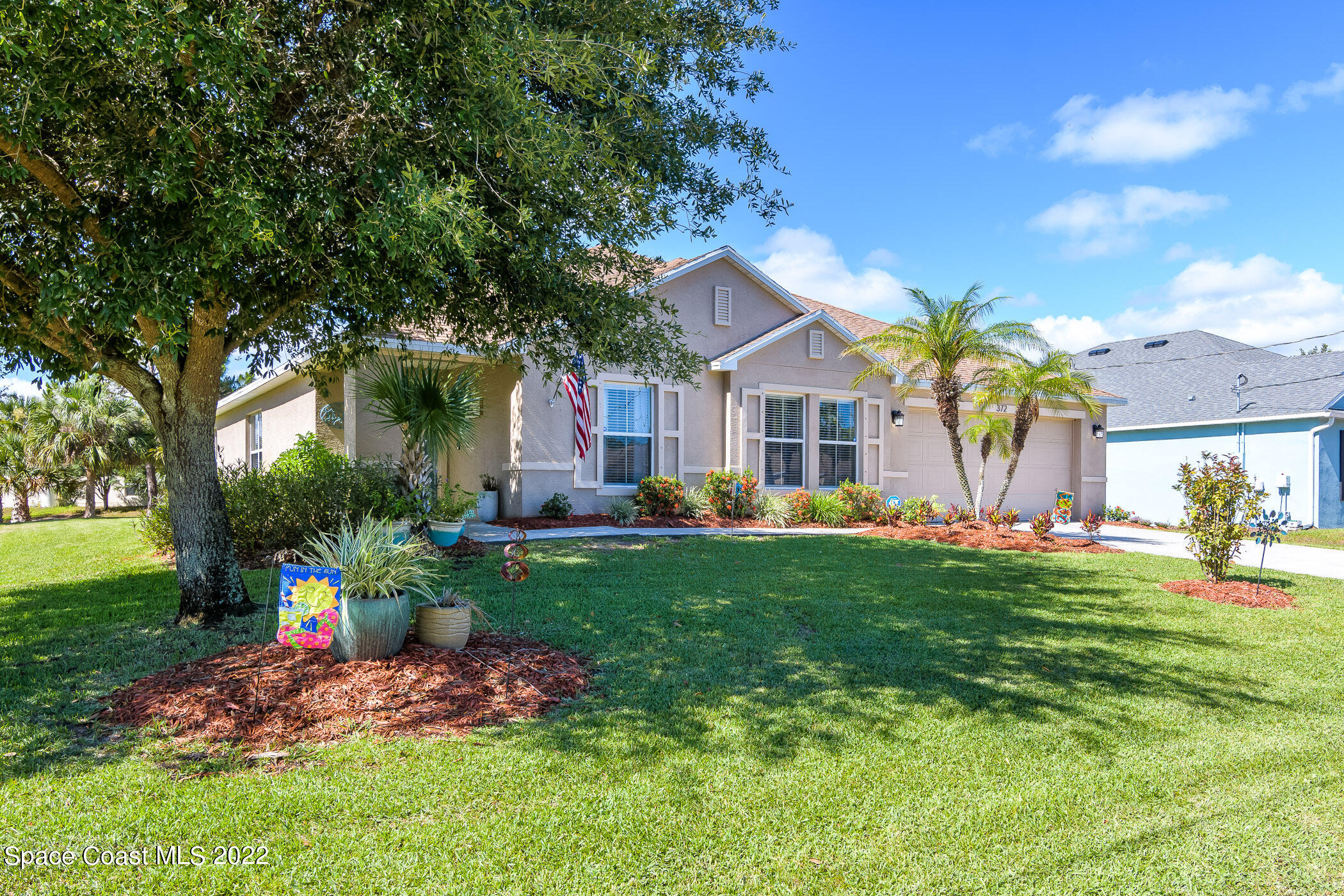 372 Franzing Street Palm Bay, FL 32908 - Photo 23 of 23 a front view of a house with garden
