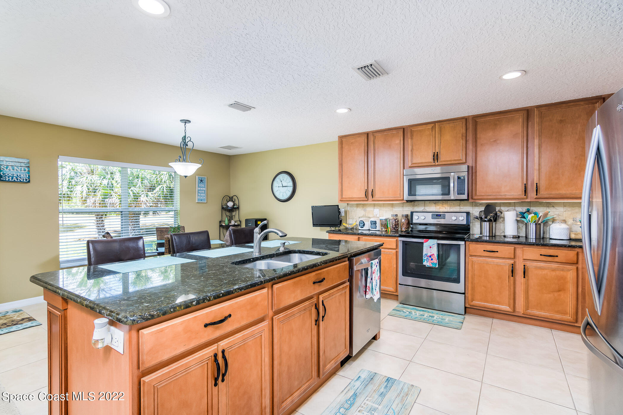 372 Franzing Street Palm Bay, FL 32908 - Photo 6 of 23 a kitchen with stainless steel appliances granite countertop a stove sink and cabinets