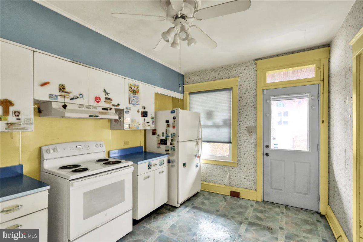 1525 North 14th Street Reading, PA 19604 - Photo 12 of 28 a kitchen with a stove a sink and a refrigerator