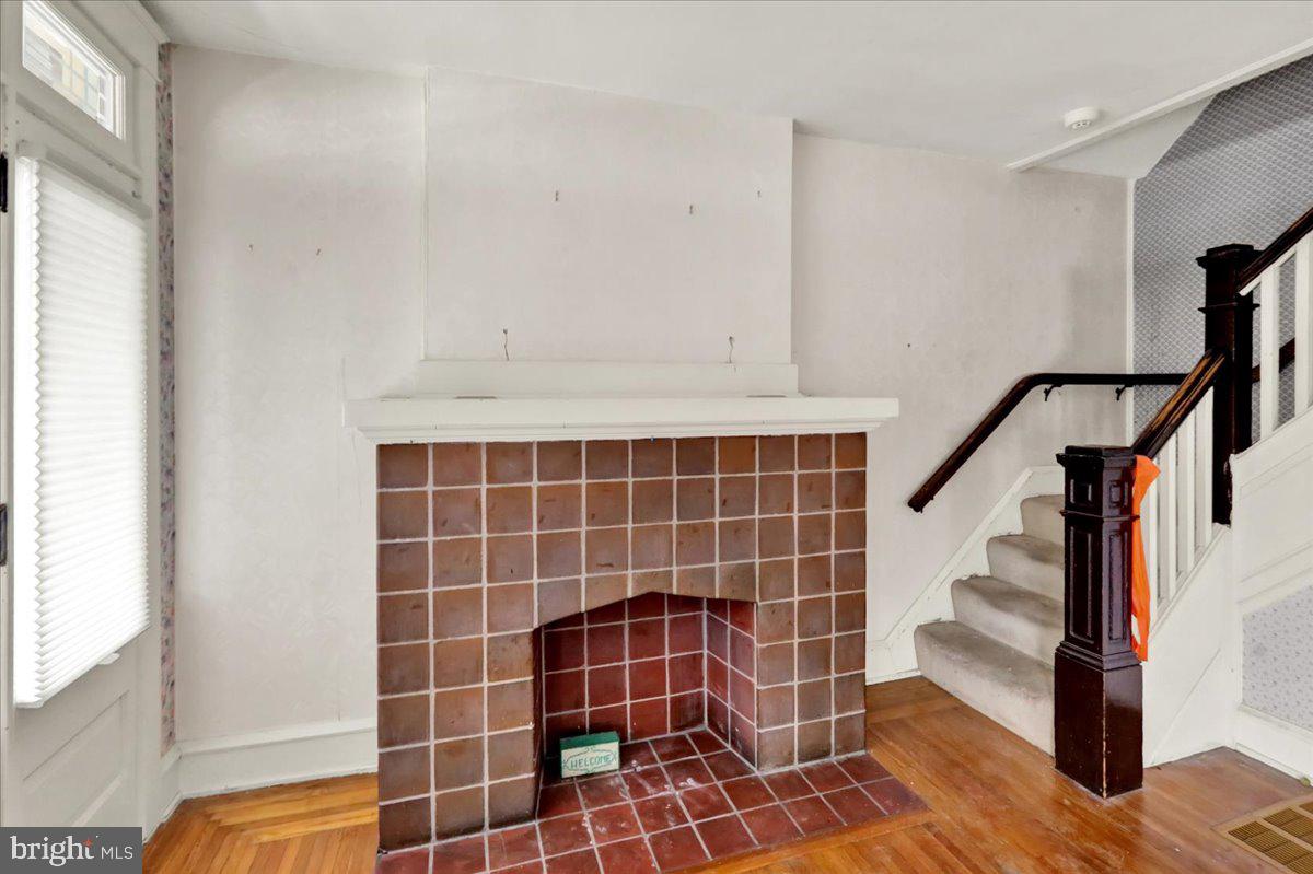 1525 North 14th Street Reading, PA 19604 - Photo 6 of 28 a view of an empty room with wooden floor and windows