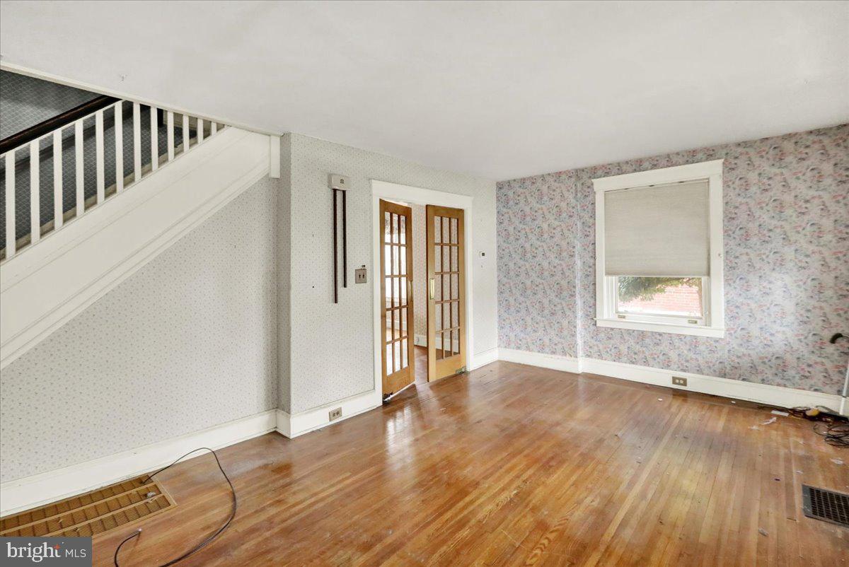 1525 North 14th Street Reading, PA 19604 - Photo 8 of 28 a view of an empty room with wooden floor and a window