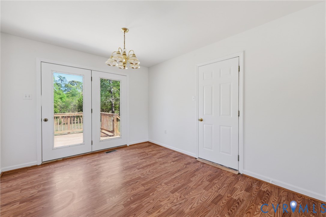 5816 Abilene Road Farmville, VA 23901 - Photo 11 of 26 a view of an empty room with wooden floor and a window