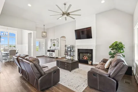 a living room with furniture a fireplace and a flat screen tv