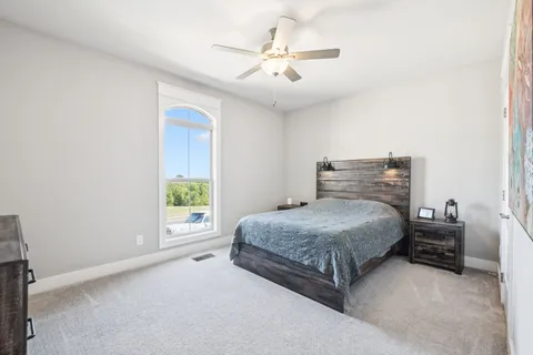 a bedroom with a bed and a window