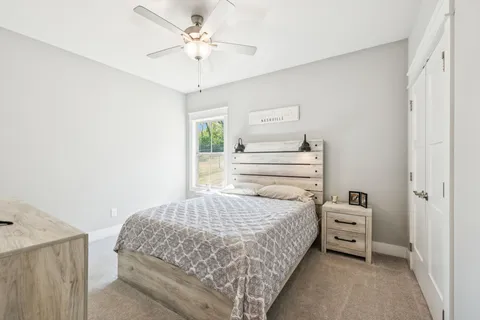 a bedroom with a bed and a chandelier