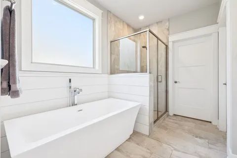 a bathroom with a bathtub and a shower