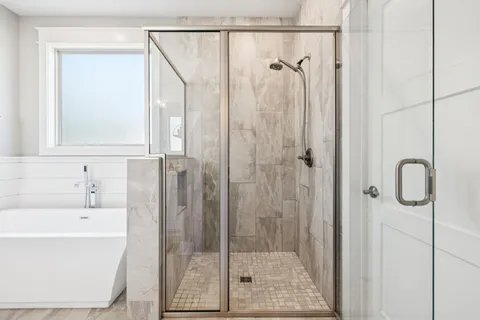 a bathroom with a shower a sink and a mirror