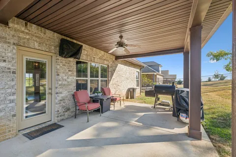 a view of a patio with table and chairs and potted plants