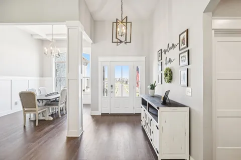 a hallway with furniture and wooden floor