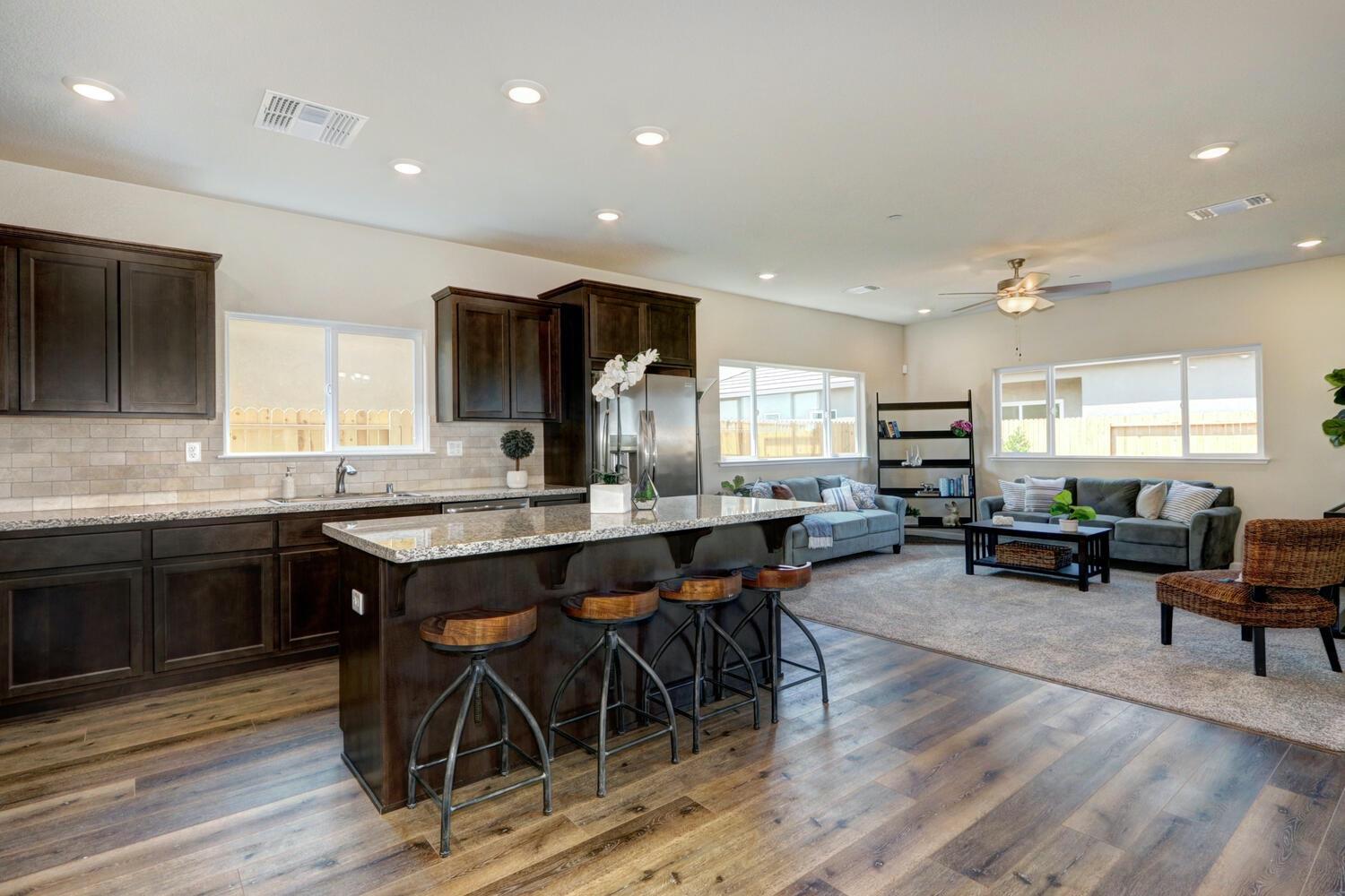 1071 Hogan Road Galt, CA 95632 - Photo 7 of 17 a large kitchen with lots of furniture a sink appliances and dining table