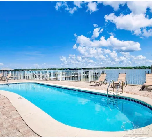 a view of a chairs and table on the roof deck