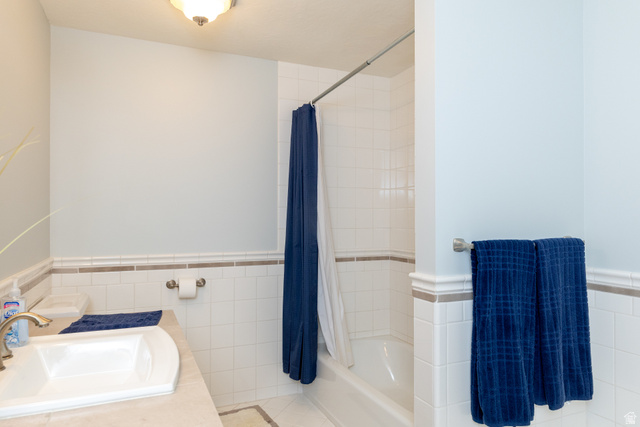 434 Cardon Ridge Drive Smithfield, UT 84335 - Photo 42 of 59 Bathroom featuring tile walls, a wainscoted wall, vanity, shower / tub combo, and tile patterned flooring
