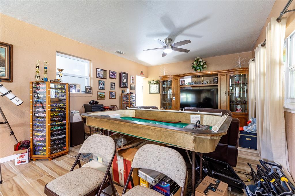 402 Southeast 709th Street Old Town, FL 32680 - Photo 12 of 37 a view of a dining room with furniture and a flat screen tv