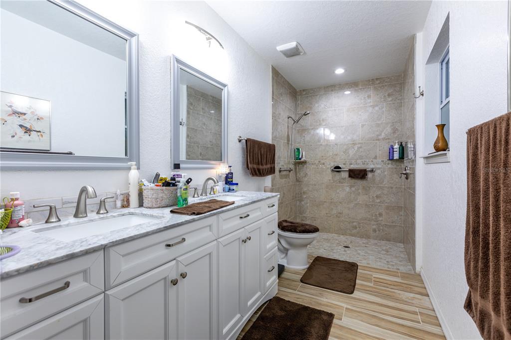 402 Southeast 709th Street Old Town, FL 32680 - Photo 18 of 37 a spacious bathroom with a granite countertop sink mirror and double