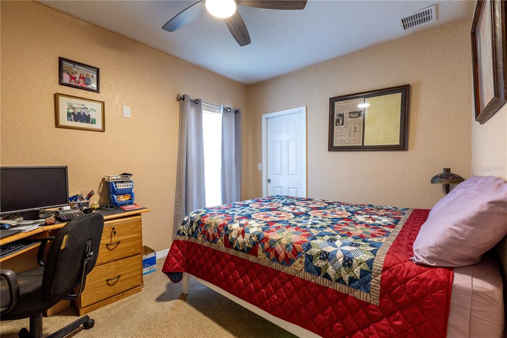 402 Southeast 709th Street Old Town, FL 32680 - Photo 20 of 37 a bedroom with a bed and a flat screen tv