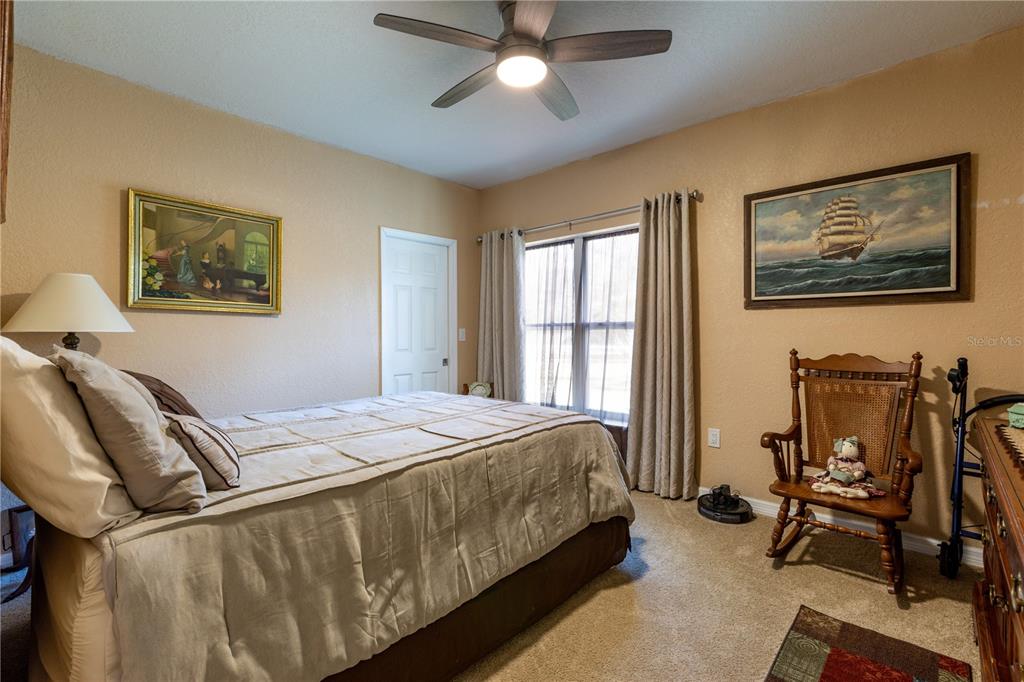 402 Southeast 709th Street Old Town, FL 32680 - Photo 21 of 37 a bedroom with a bed and chair