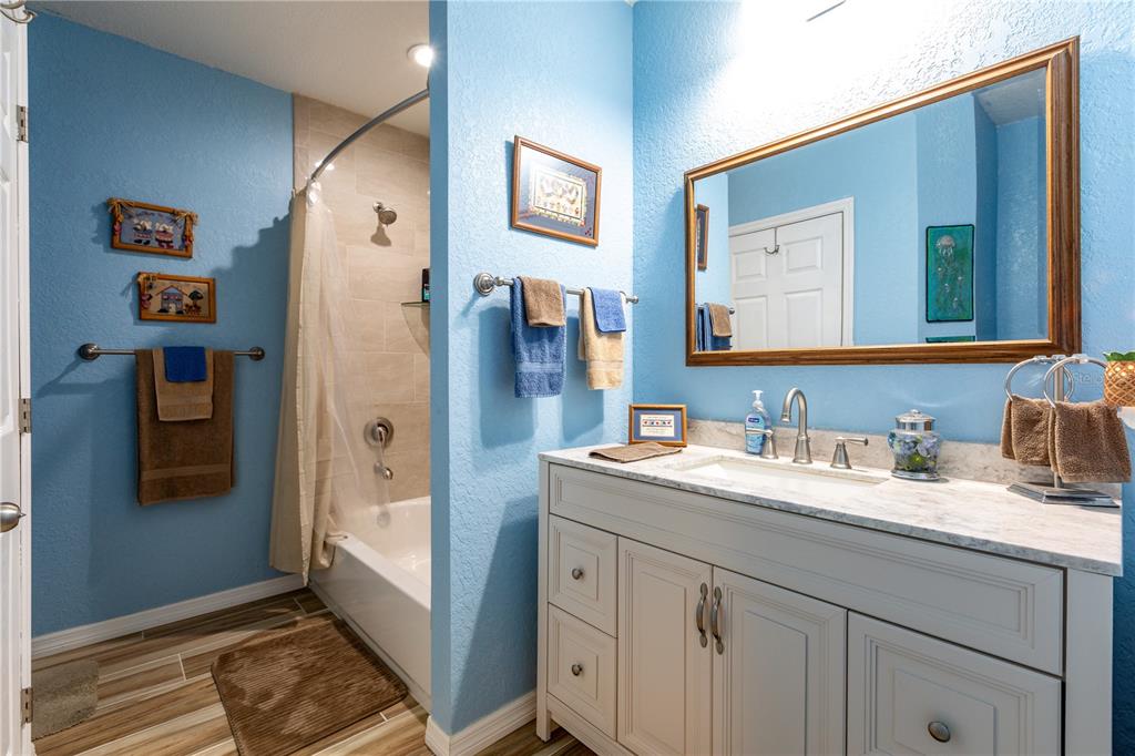402 Southeast 709th Street Old Town, FL 32680 - Photo 22 of 37 a spacious bathroom with a granite countertop sink and a mirror