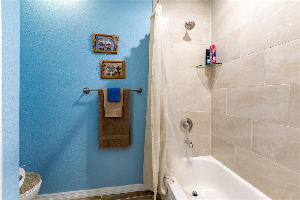 402 Southeast 709th Street Old Town, FL 32680 - Photo 23 of 37 a bathroom with a tub and a shower