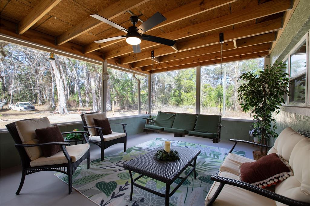 402 Southeast 709th Street Old Town, FL 32680 - Photo 28 of 37 a outdoor living space with furniture and a large window