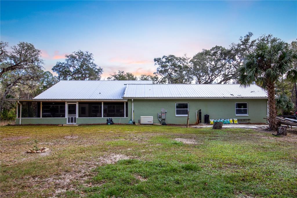 402 Southeast 709th Street Old Town, FL 32680 - Photo 29 of 37 a view of a house with a yard and sitting area