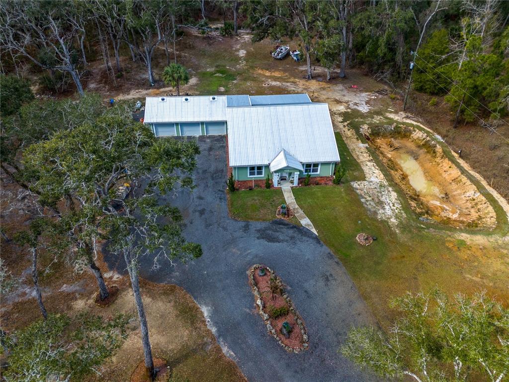 402 Southeast 709th Street Old Town, FL 32680 - Photo 4 of 37 an aerial view of a house with garden space and street view