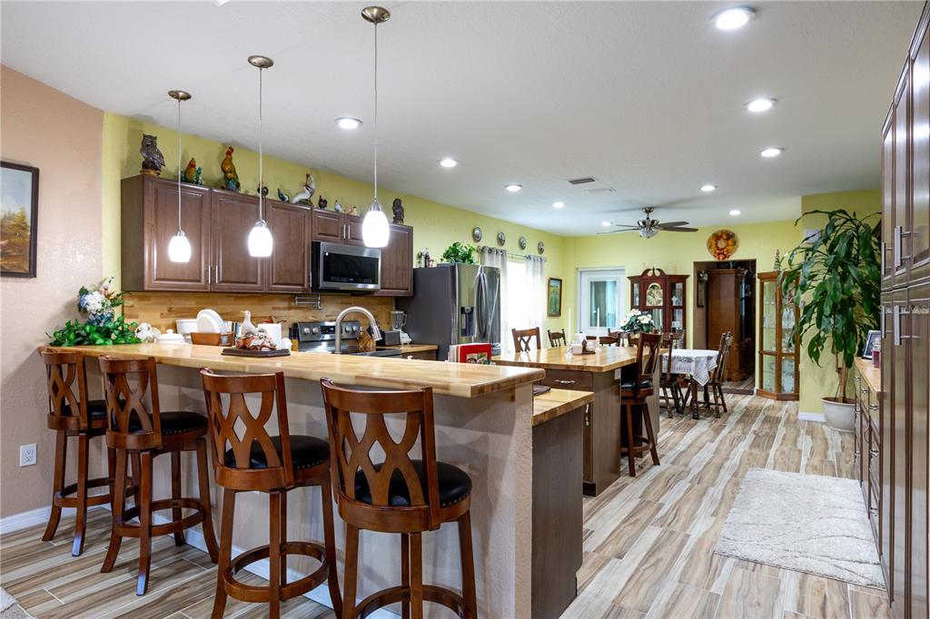 402 Southeast 709th Street Old Town, FL 32680 - Photo 7 of 37 a kitchen with lots of wooden furniture appliances and furniture