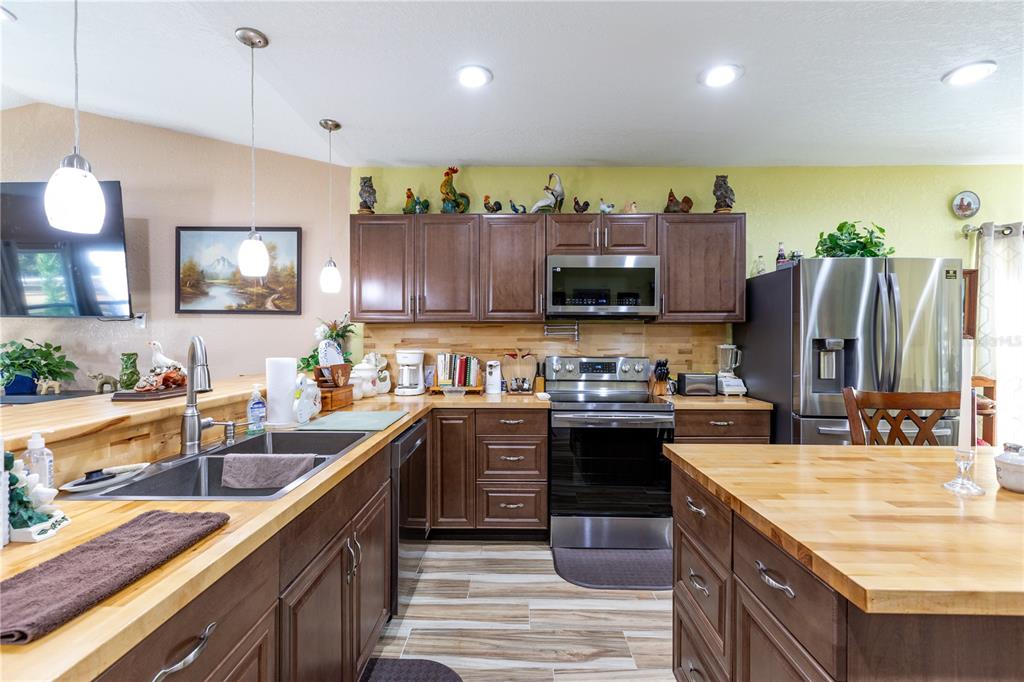 402 Southeast 709th Street Old Town, FL 32680 - Photo 8 of 37 a kitchen with stainless steel appliances granite countertop a sink stove and refrigerator
