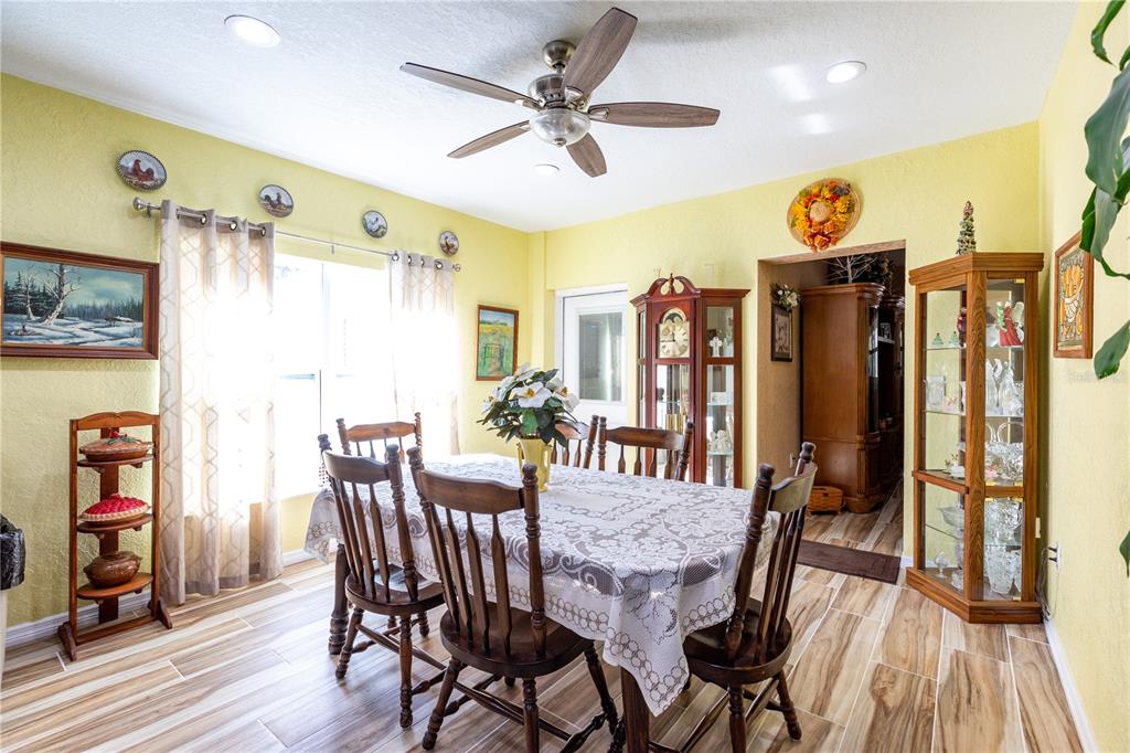 402 Southeast 709th Street Old Town, FL 32680 - Photo 10 of 37 a view of a dining room with furniture window and wooden floor
