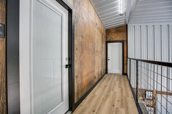 a bed sitting in a spacious bedroom next to a window