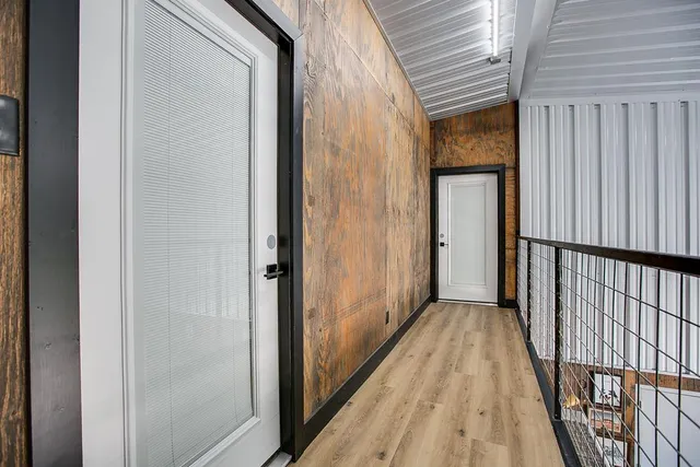 a bed sitting in a spacious bedroom next to a window