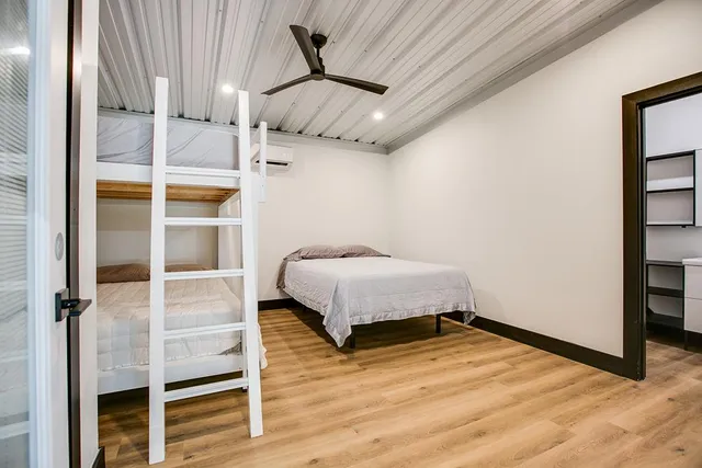 a bedroom with a bed and wooden floor
