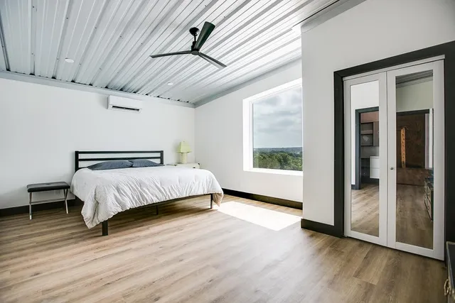 a dining room with wooden floor and stairs