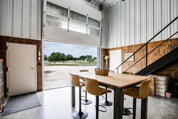 a bedroom with a bed and painting on the wall