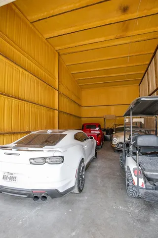 a dining hall with couches a dining table and chairs with wooden floor