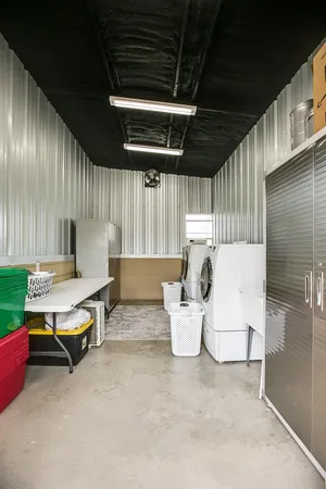 a dining room with furniture and a floor to ceiling window
