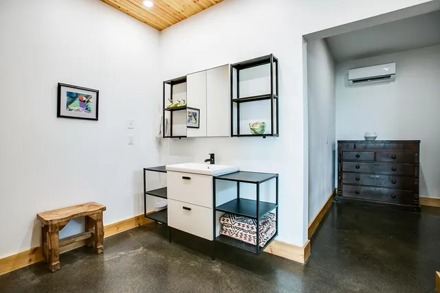 a bathroom with a sink toilet and blue shower
